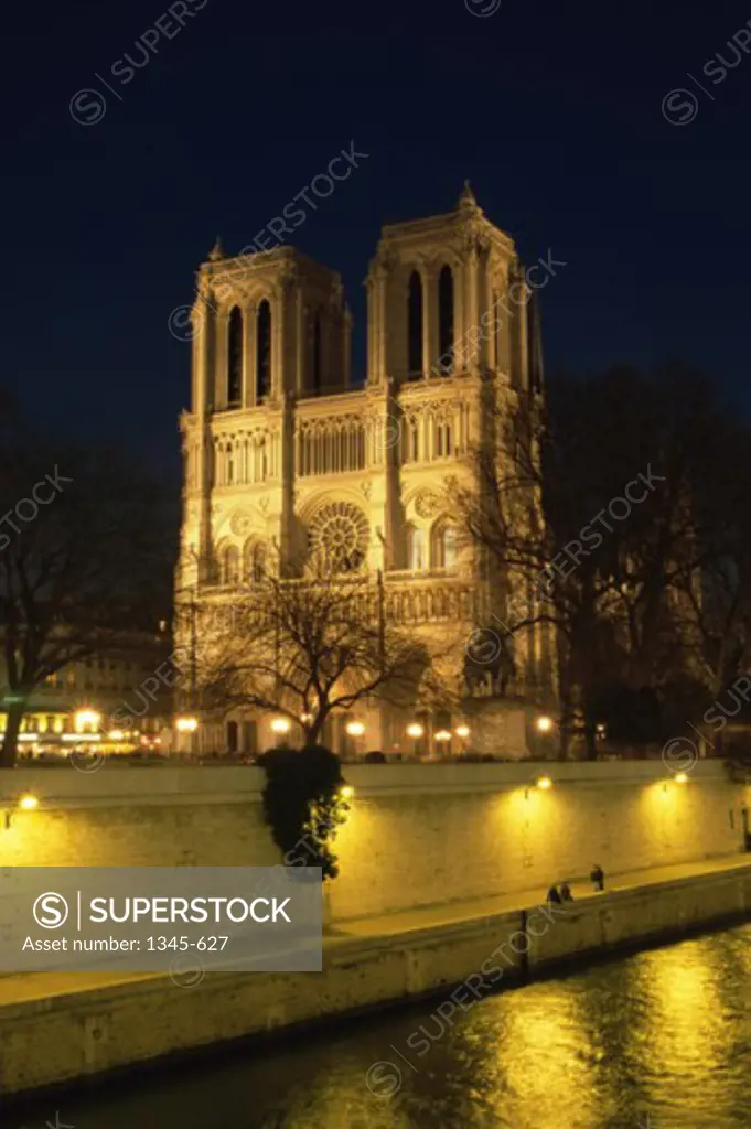 Low angle view of a cathedral lit up at night, Notre Dame, Paris, France