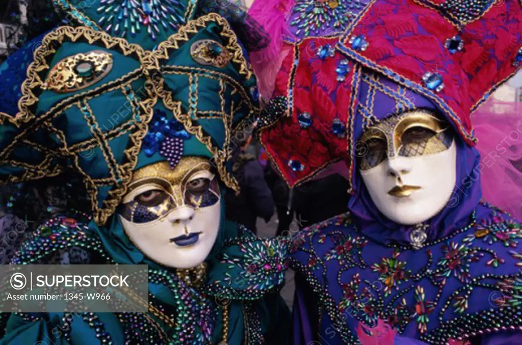 Portrait of two people wearing masquerade masks, Venice, Italy