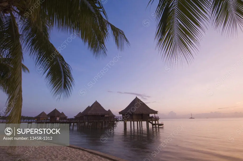 Stilt houses at a tourist resort on the beach, Hotel Kia Ora, Rangiroa, Tuamotu Archipelago, French Polynesia