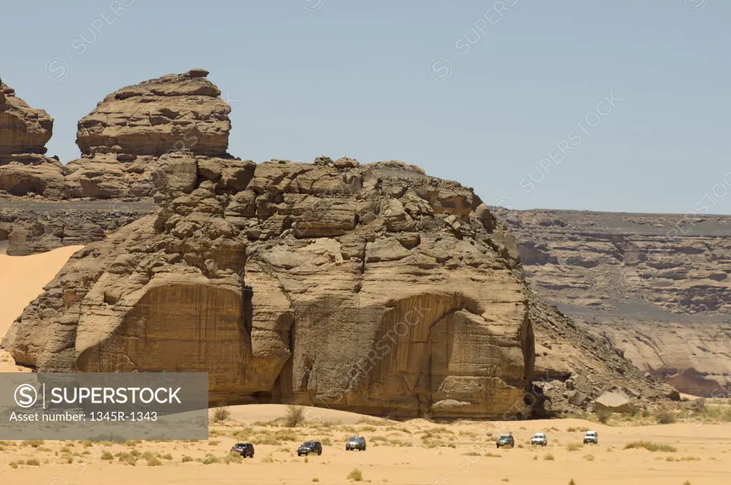4x4 vehicles near rock formations, Wadi Teshuinat, Tadrart Acacus, Fezzan, Libya