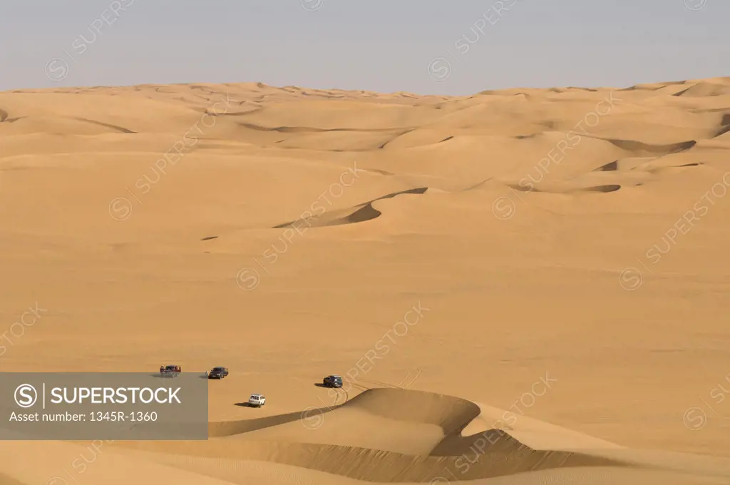 High angle view of 4x4 vehicles in a desert, Erg Awbari, Fezzan, Libya
