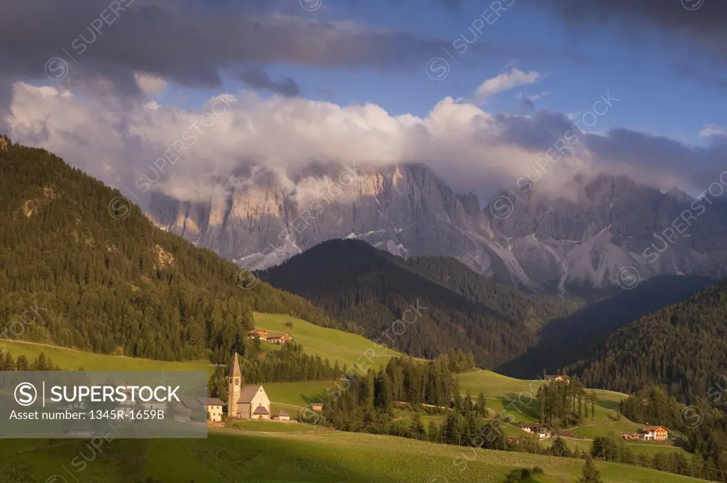 Village with mountain range on a landscape, Santa Maddalena, Funes Valley, Dolomites, Trentino-Alto-Adige, Italy