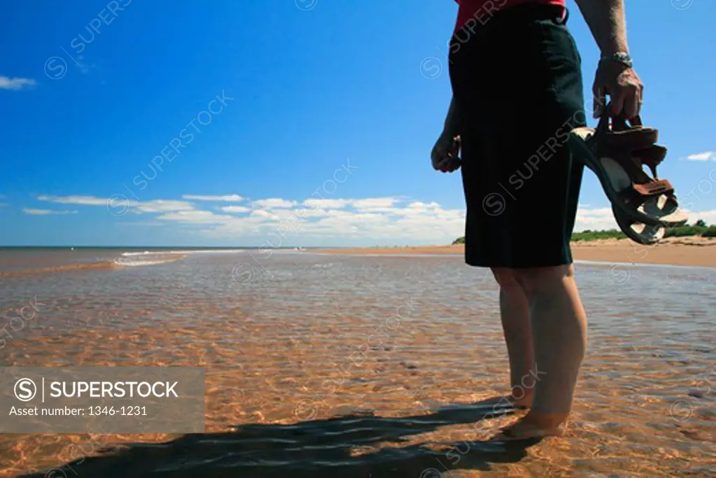 Woman standing on the beach, Covehead Bay, Prince Edward Island, Canada