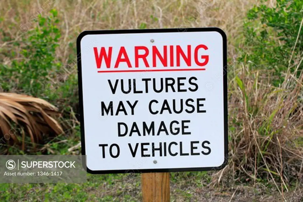 Warning sign that vultures damage vehicles