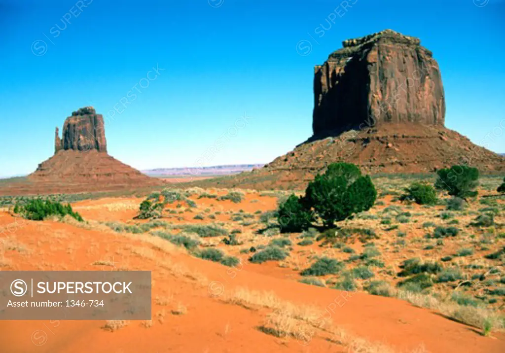 Rock formations on an arid landscape, West Mitten Butte, Merrick Butte, Monument Valley, Arizona, USA