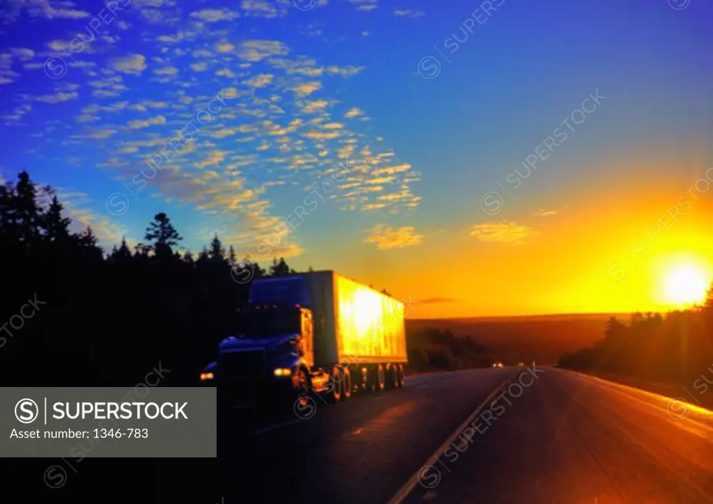 Semi-truck on the road at dawn