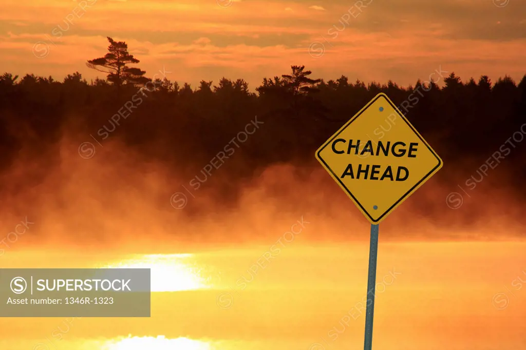 Canada, Nova Scotia, Caution sign beside lake at sunrise