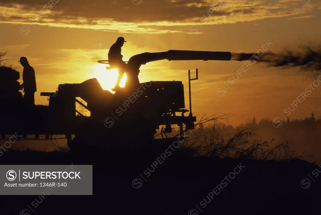 Silhouette of heavy machinery on a farm