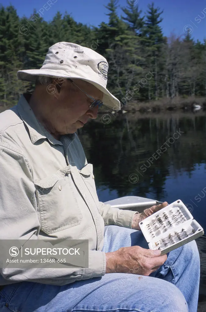 Senior man looking at fishing lures