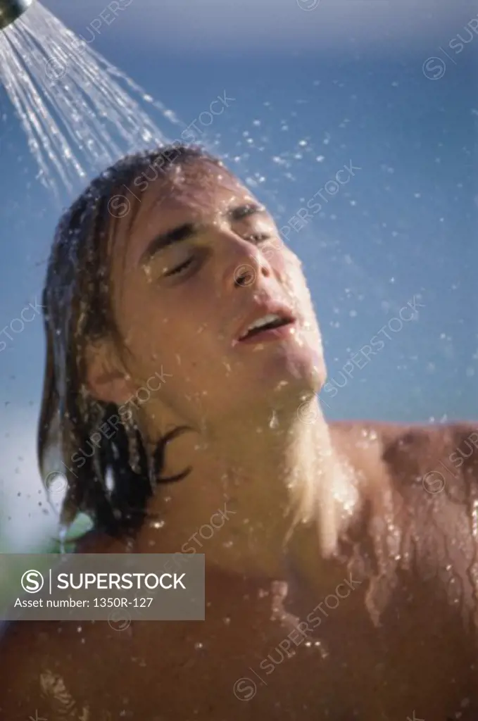 Young man taking a shower
