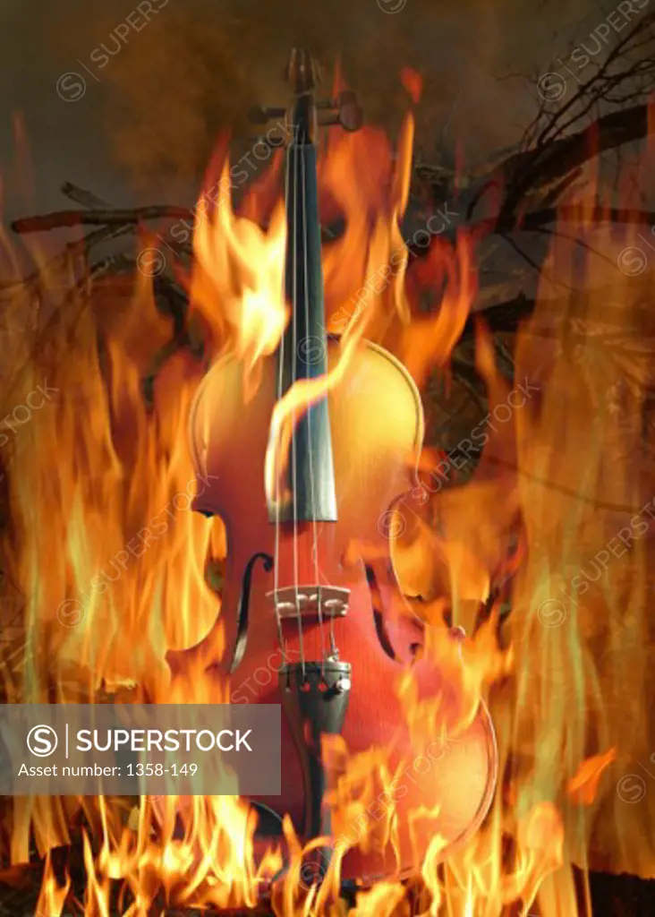 Close-up of a cello superimposed on flames