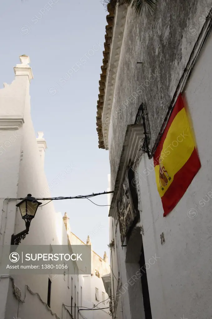 Spanish flag on the wall of a house, Vejer De La Frontera, Cadiz Province, Andalusia, Spain