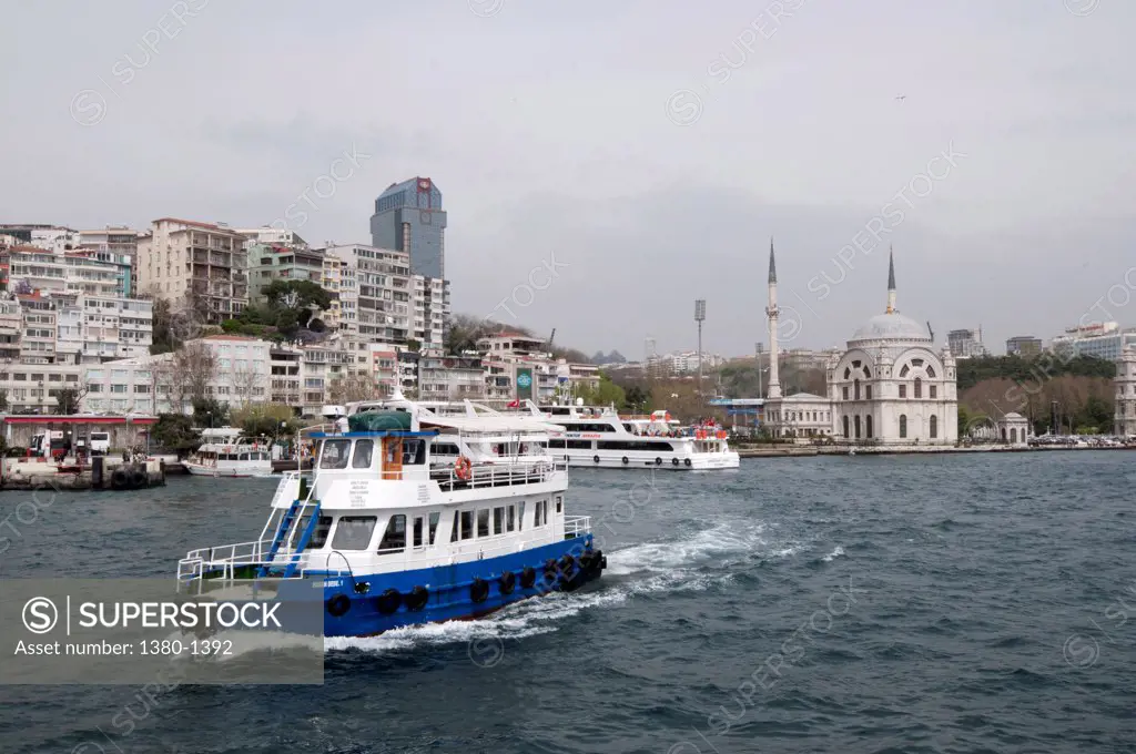 Ferry in the sea with Ortakoy Mosque in the background, Istanbul, Turkey