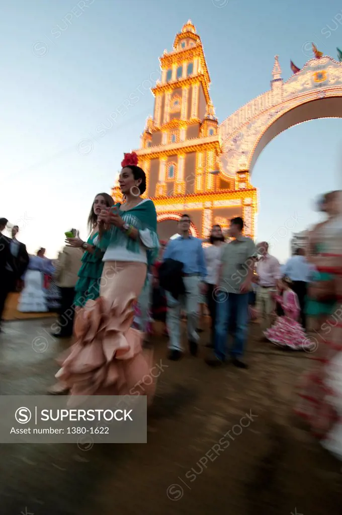 People in front of the entrance gate during the Seville Fair, Seville, Andalusia, Spain
