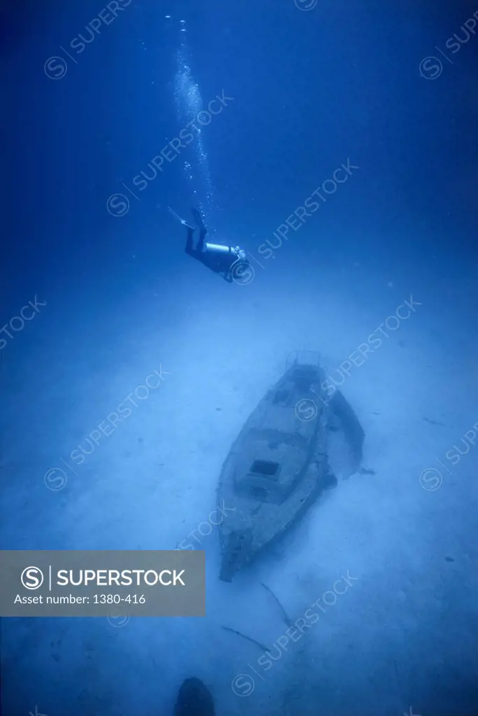 High angle view of a scuba diver near an underwater shipwreck