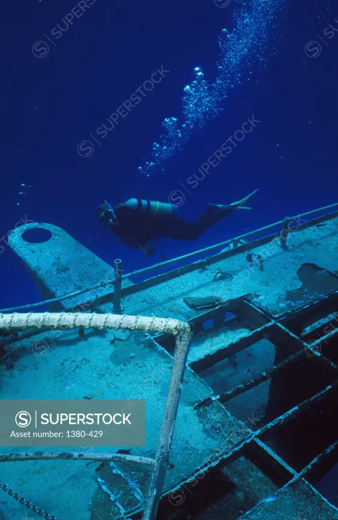 High angle view of a scuba diver near an underwater shipwreck, Cayman Islands