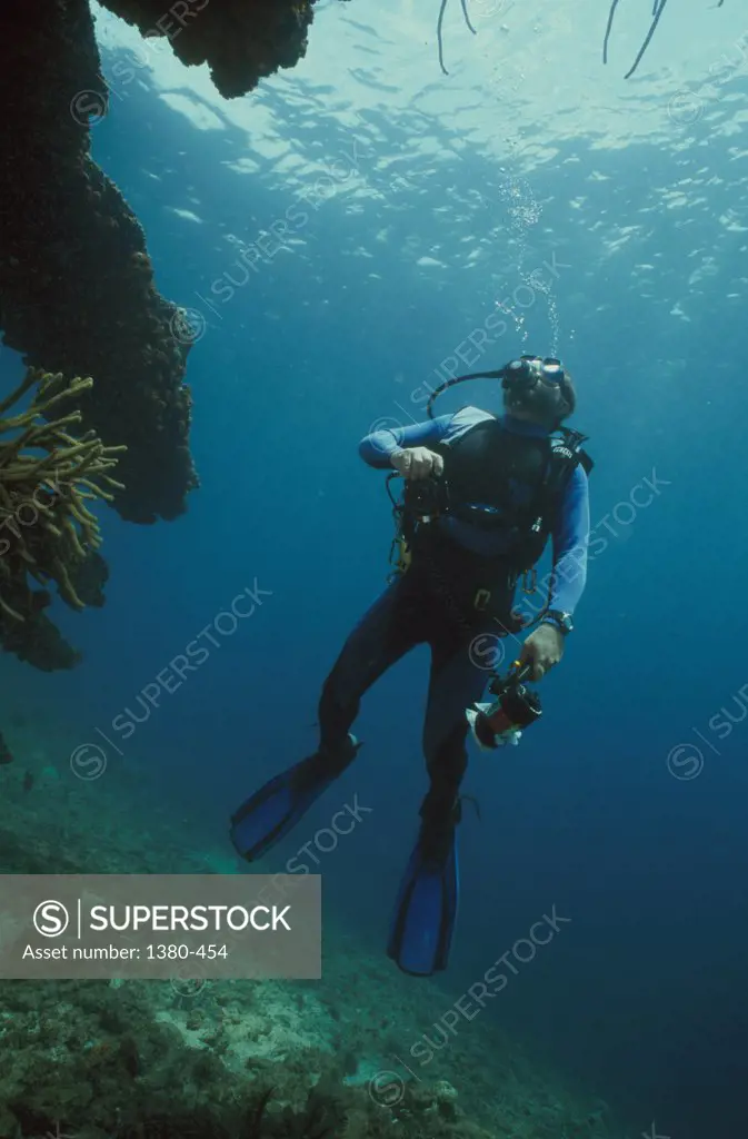 Scuba diver underwater near a reef, Venezuela