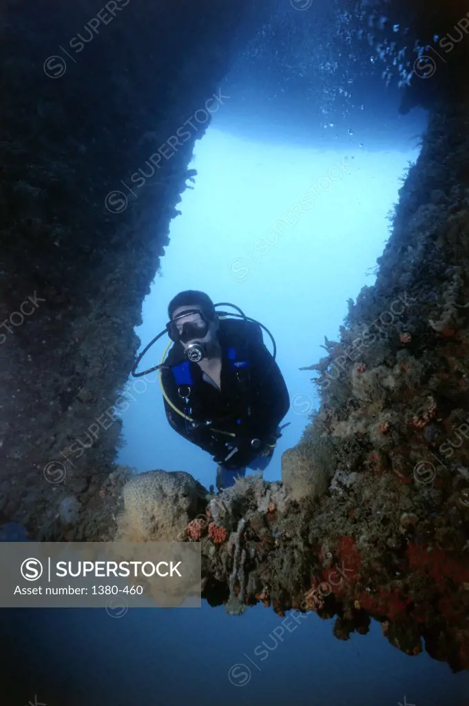 Scuba diver underwater near a reef, Venezuela