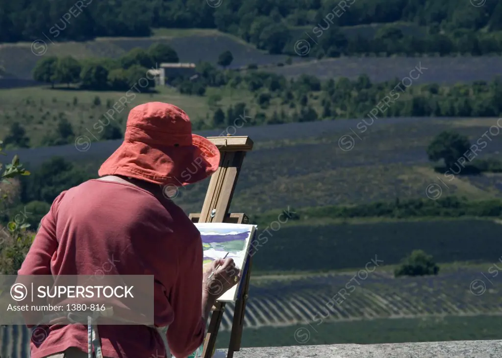Painter painting the picture of lavender fields, Sault, Provence-Alpes-Cote d'Azur, France