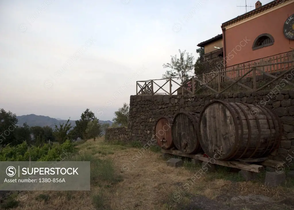 Wine barrels in front of a winery, Linguaglossa, Catania Province, Sicily, Italy