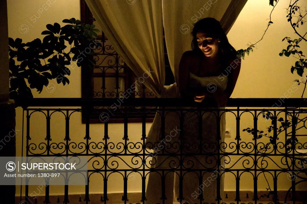 Mid adult woman leaning on a balcony, Medina, Marrakesh, Morocco