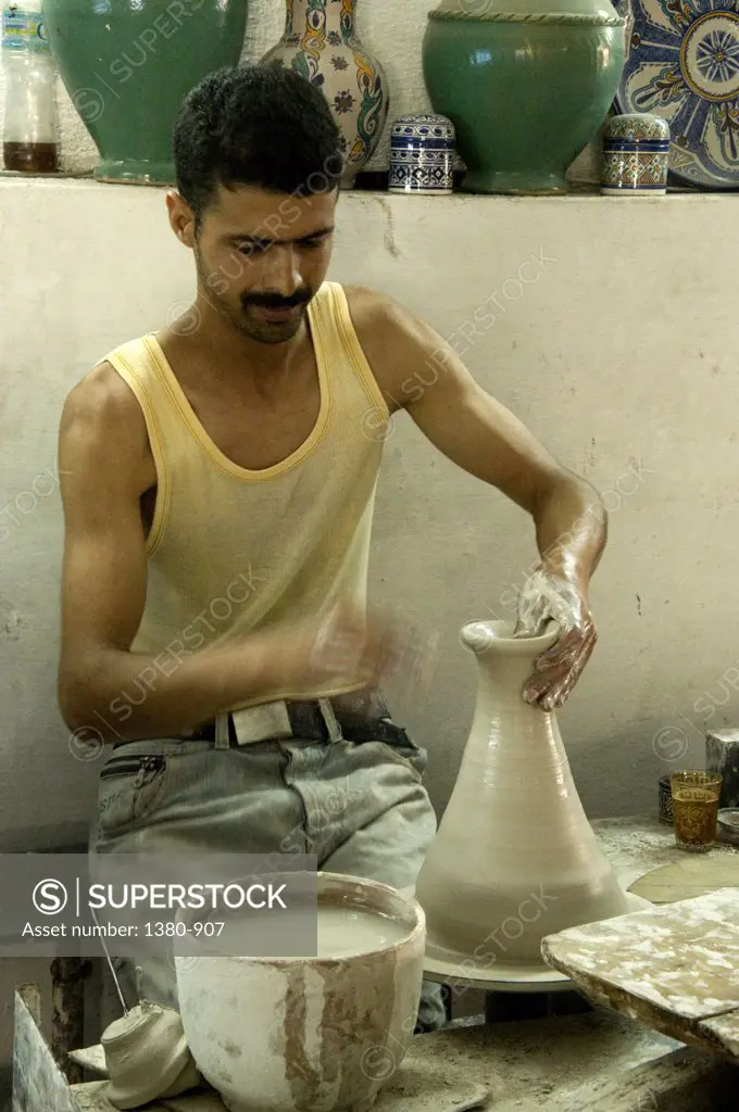 Man making a pot on a pottery wheel, Fez, Morocco