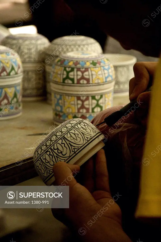 Close-up of a potter painting pottery, Fez, Morocco