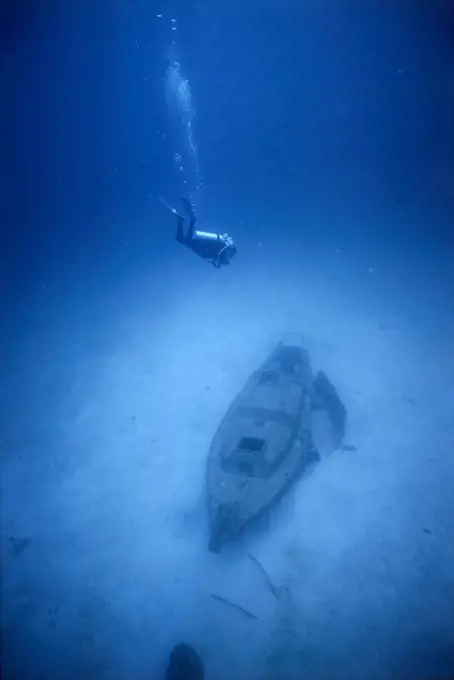 High angle view of a scuba diver near an underwater shipwreck
