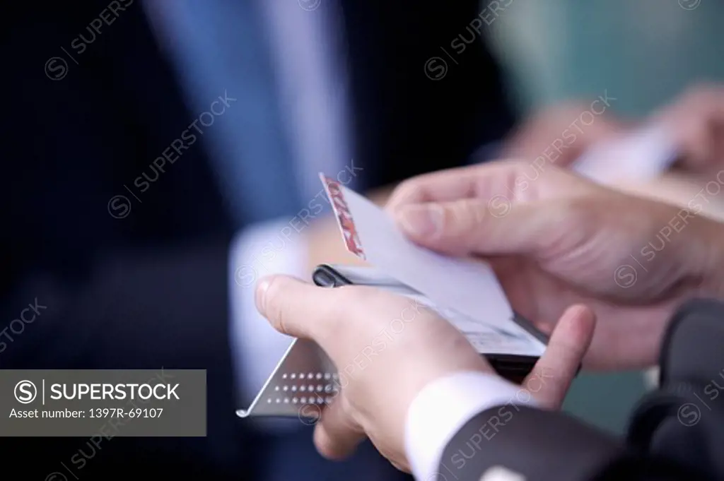 Close-up of human's hands holding a rotary card file