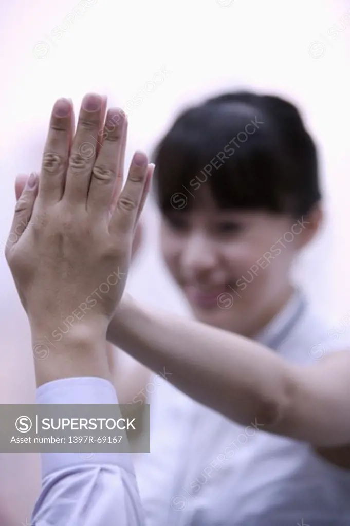 Young woman making give me five with a hand