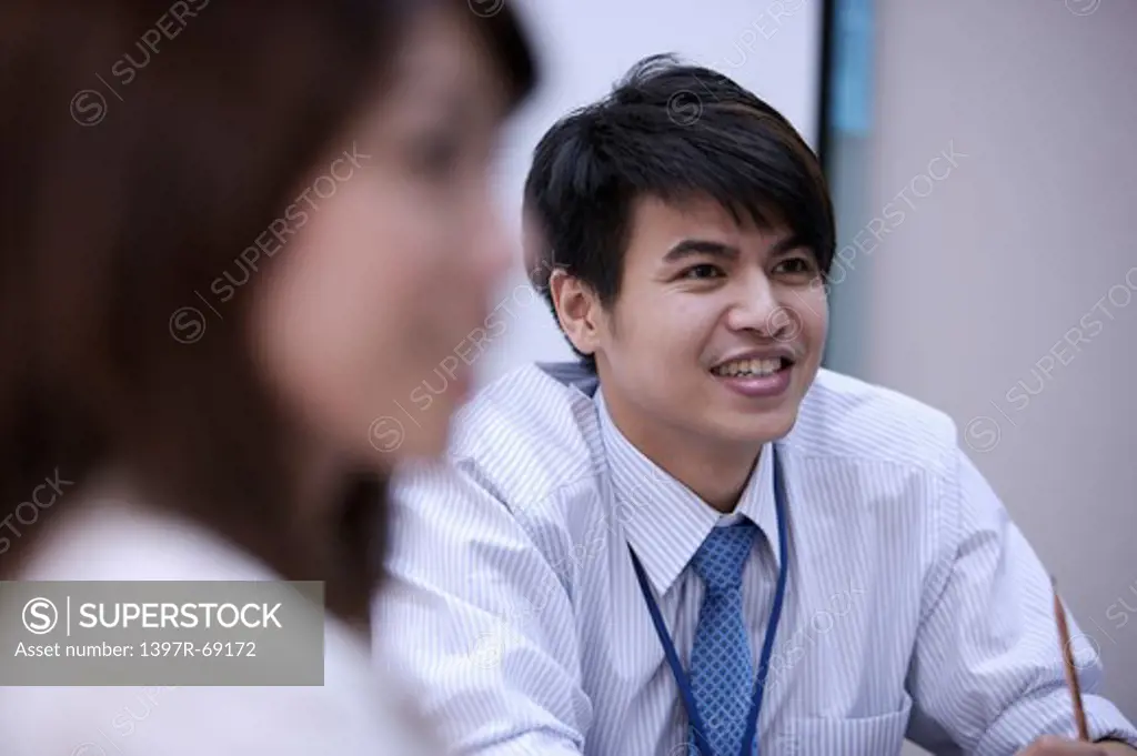 Young man looking away and smiling happily