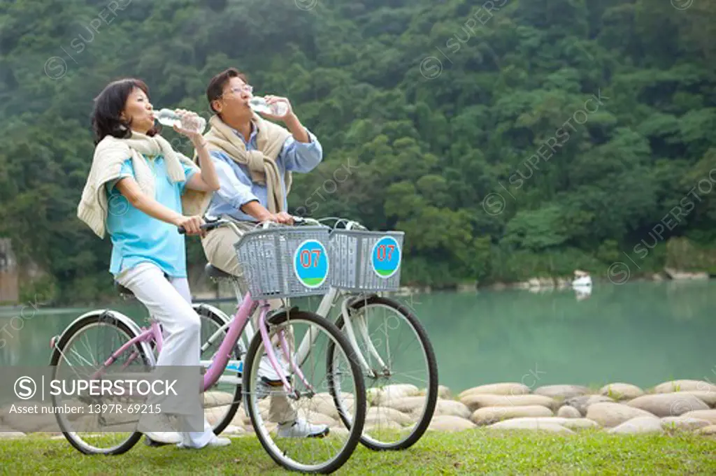 Couple, Couple riding on bikes and drinking water together