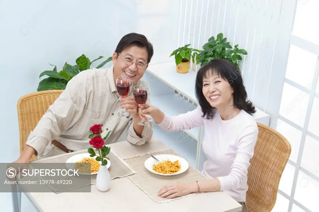 Couple, Couple holding glass of wine and looking up with smile