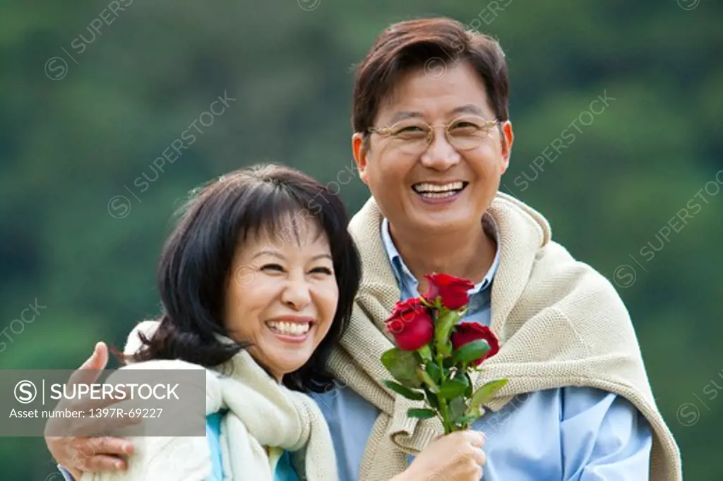 Couple, Couple bonding together, holding red roses and smiling happily