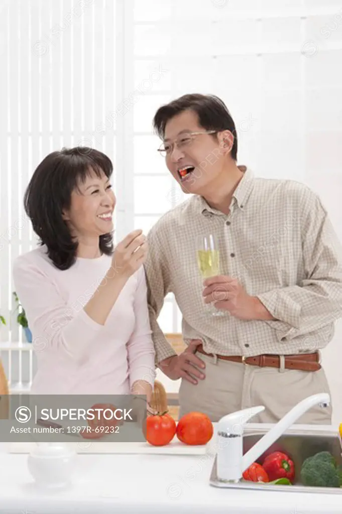 Couple, Couple eating food in kitchen and smiling happily