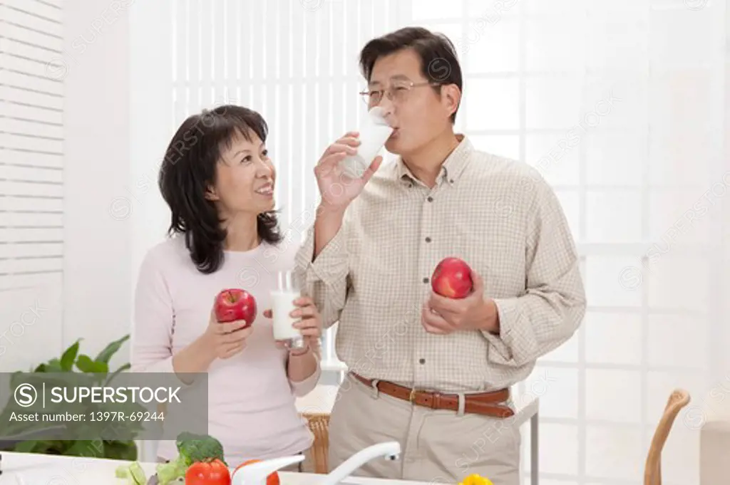 Couple, Couple holding apple and glass of drink together