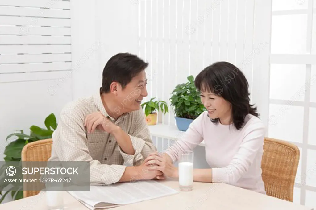 Couple, Couple sitting on the table and holding hands with smile