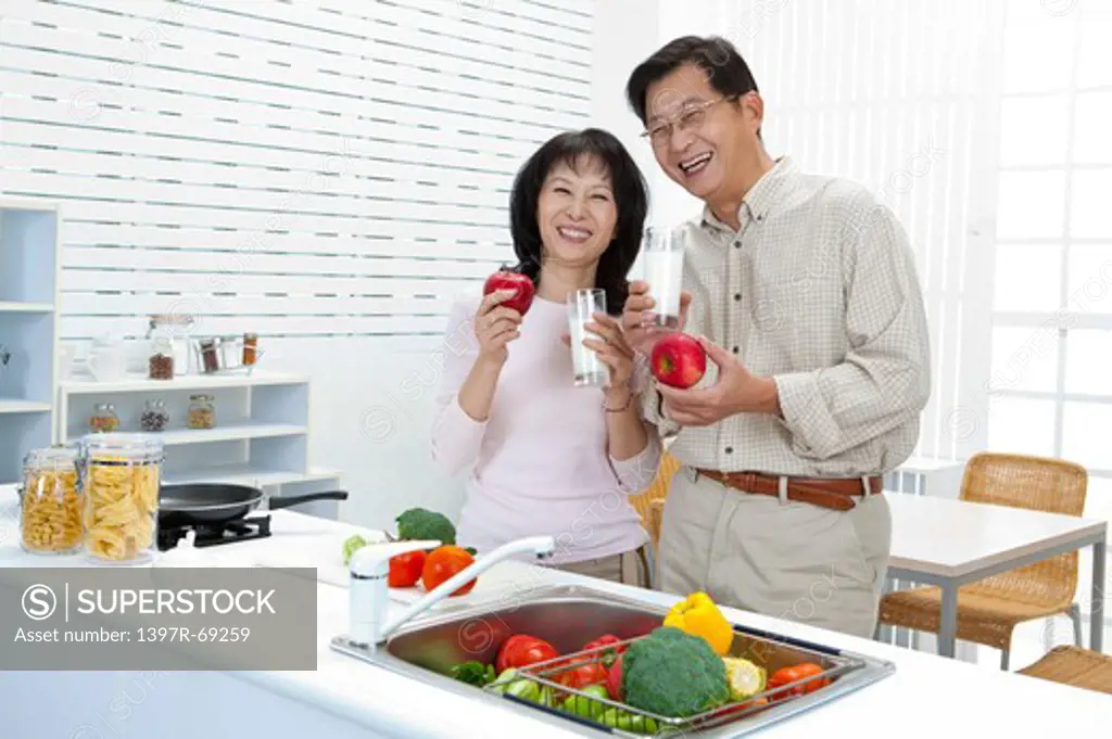 Couple, Couple holding apple and glass of milk with smile