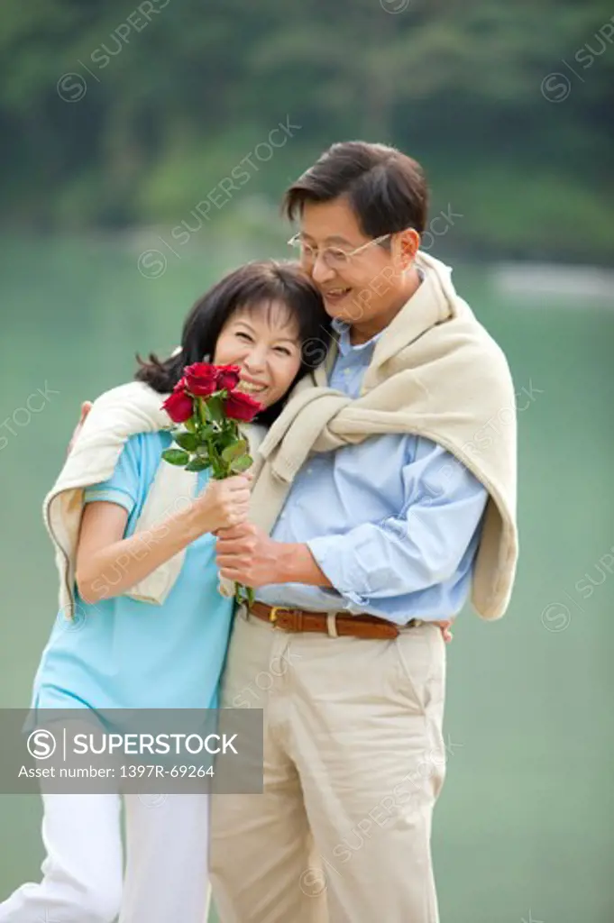 Couple, Couple bonding together and holding red roses with smile