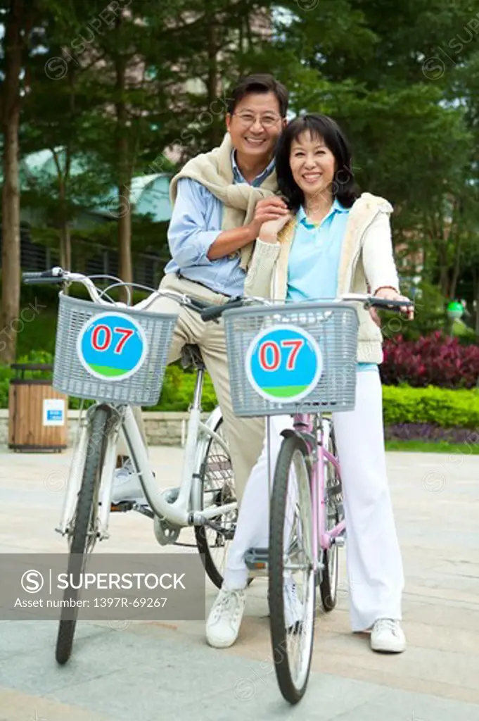 Couple, Couple riding on bikes, holding hands and smiling