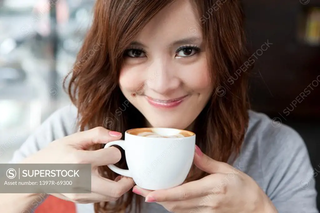 Coffee Break, Taste of Life, Young woman drinking a cup of coffee with smile