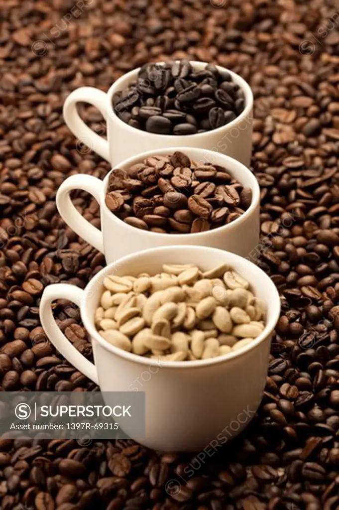 Coffee Bean, Coffee Culture, Close-up of three cups of coffee beans on a stack of coffee beans