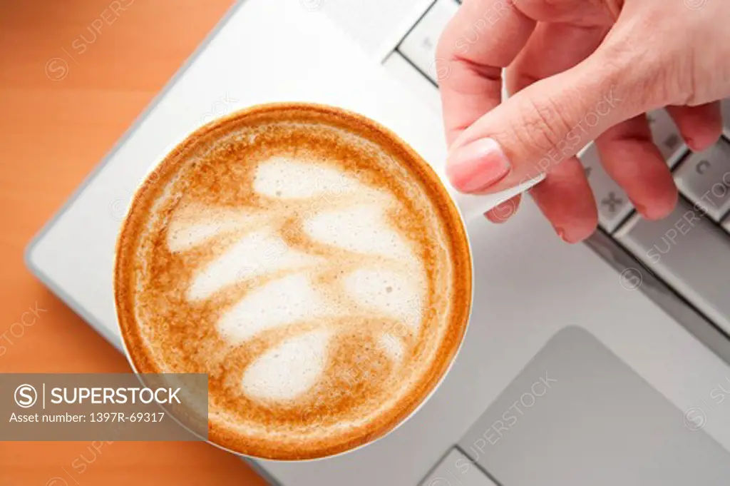 Coffee, Human hand holding a cup of cappuccino with pattern
