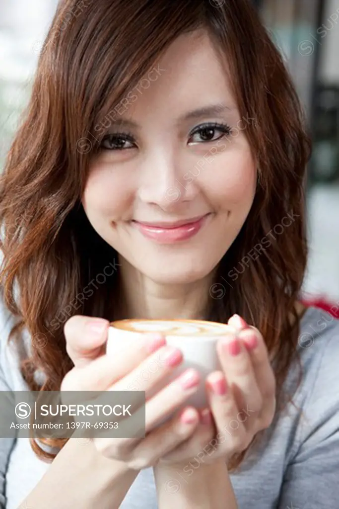 Coffee Break, Taste of Life, Young woman holding a cup of coffee and smiling at the camera