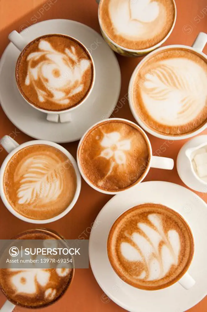 Coffee, Cappuccino, Close-up of cups of cappuccino with different pattern on the table