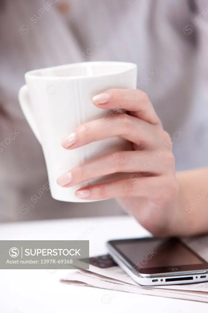 Close-up of human's hand holding a cup