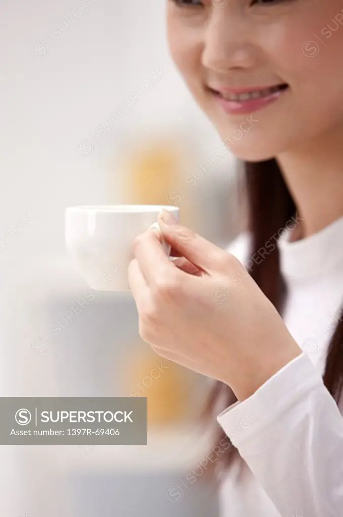 Woman holding a cup and smiling