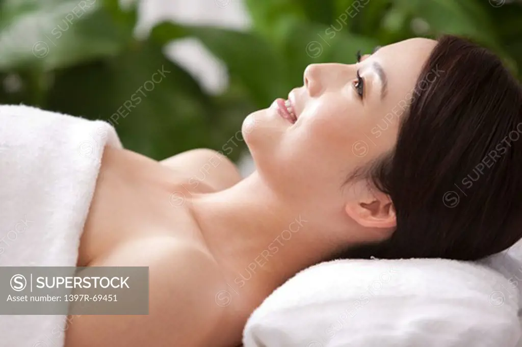 Beauty Treatment, Woman lying and looking up with smile