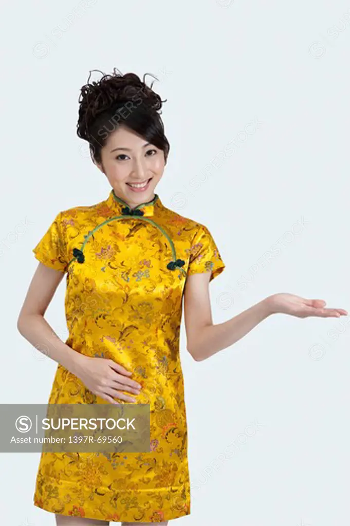 New Year, Young woman wearing Chinese traditional clothing and reaching out hand with smile