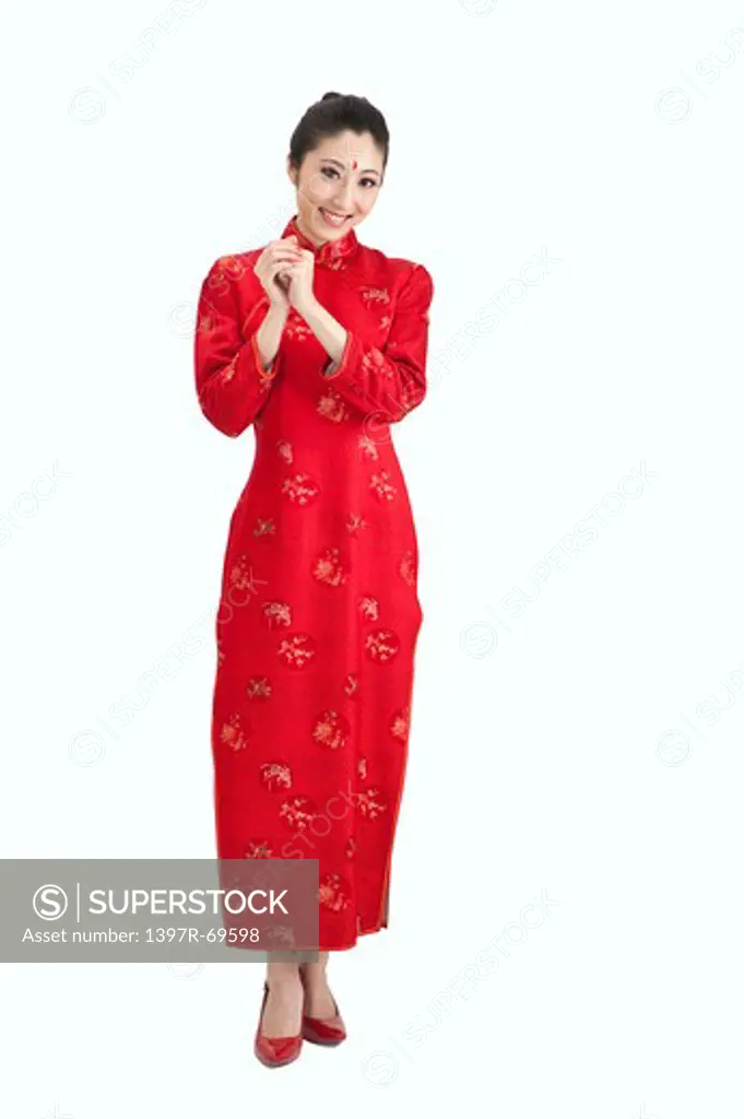 New Year, Young woman wearing Chinese traditional clothing and greeting with smile